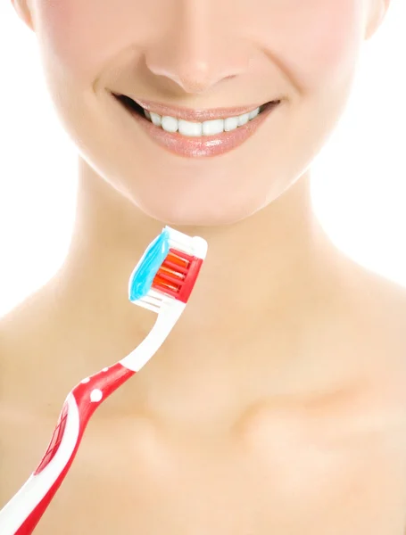 Beautiful young woman's face with a toothbrush isolated on white — Stock Photo, Image