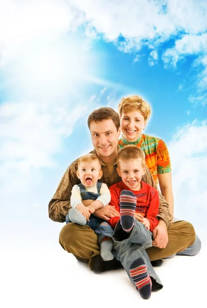 Happy family over blue sky — Stock Photo, Image