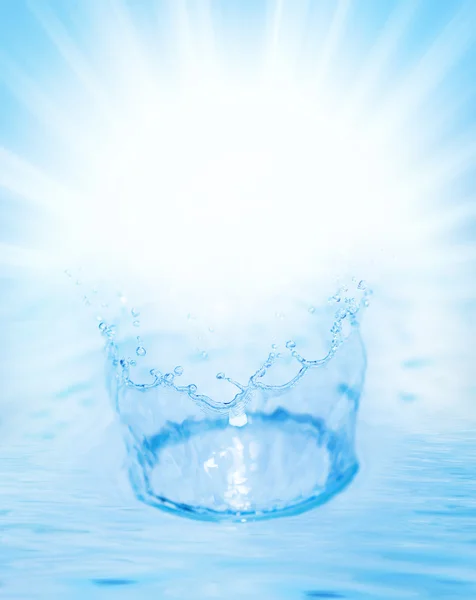 Splashing water over abstract blue background — Stock Photo, Image