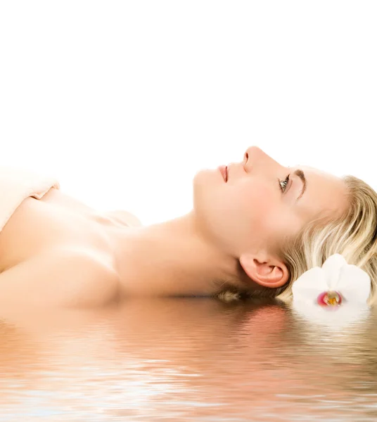 Beautiful young woman ready for spa treatment near the water Royalty Free Stock Photos