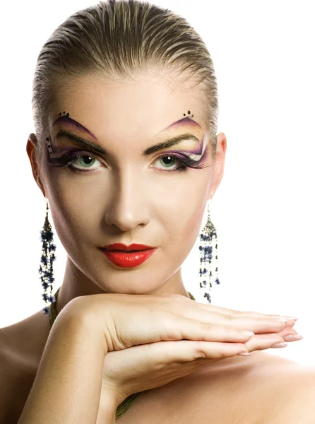 Mooie jonge vrouw met creatieve make-up op haar gezicht Stockfoto