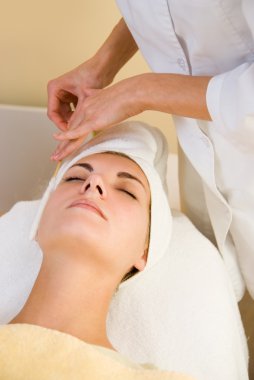 Facial cryogenic massage in spa salon clipart