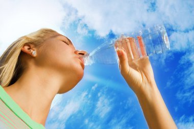 Beautiful blond girl drinking water clipart