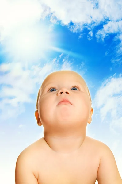 Beautiful baby over blue cloudy sky — Stock Photo, Image