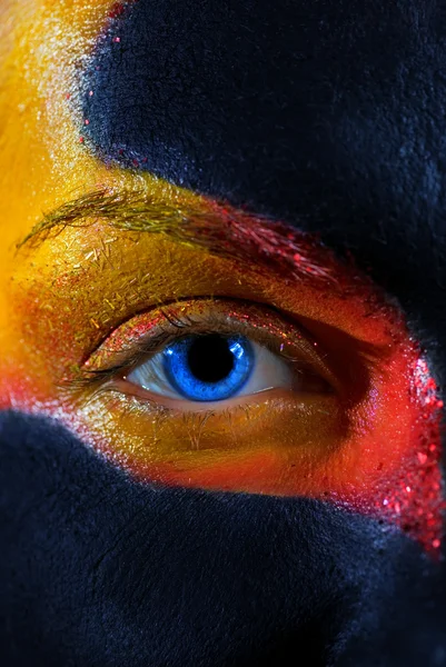 Stock image Portrait of a mysterious woman with artistic make-up on her face. Isolated on black background