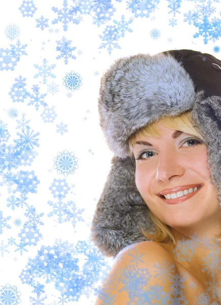 彼女の周りの冬毛皮帽と抽象的な雪片で素敵なブロンドの女の子 — ストック写真