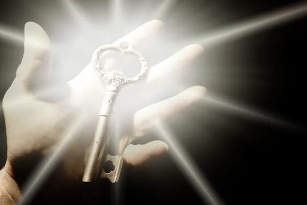 Human hand with an old key — Stock Photo, Image
