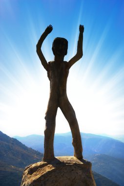 Homo sapiens sculpture in high mountains clipart