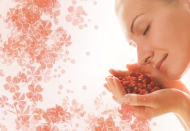 Beautiful girl with a handful of aromatic berries clipart