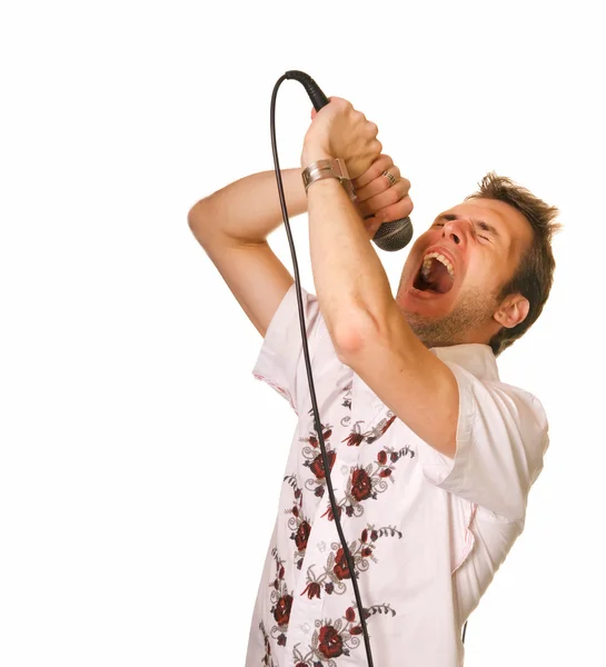 Young guy with a microphone over white backrgound — Stock Photo, Image