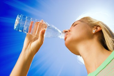 Beautiful blond girl drinking water clipart