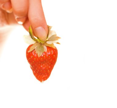 Woman's hand with a fresh strawberry isolated on white clipart