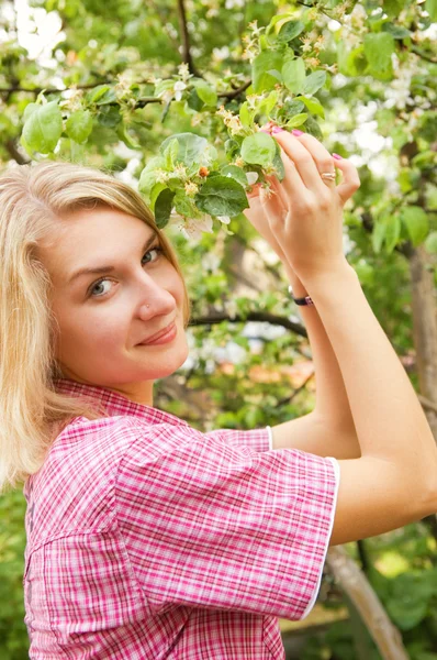 Beautiful blond girl in the garden — Stock Photo, Image