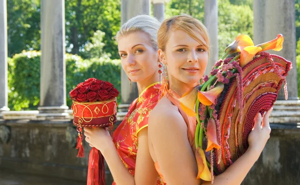 Two beautiful girls with luxury bouquets — Stock Photo, Image