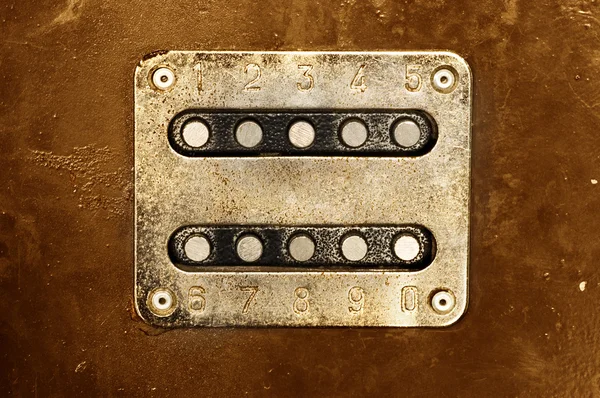 Rusty metal panel with buttons and numbers — Stock Photo, Image