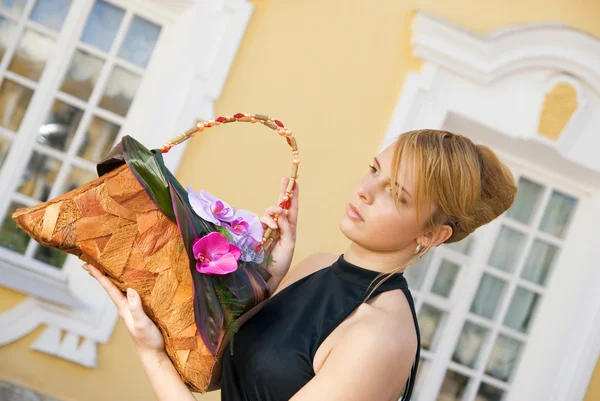 Mooi roodharig meisje met een florale handtas — Stockfoto