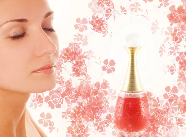 Beautiful girl's face and small perfume phial on abstract backgr — Stock Photo, Image