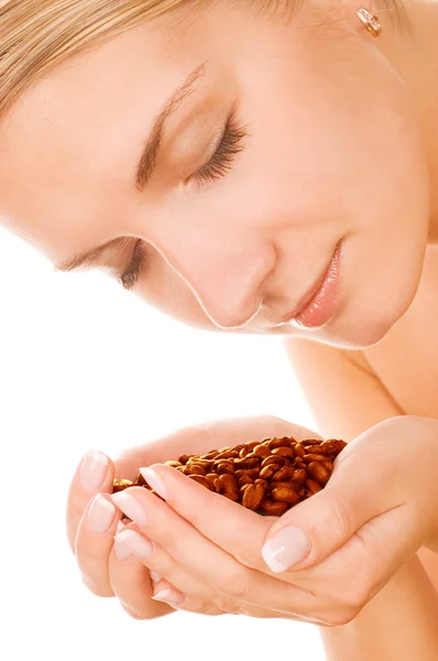 Beautiful girl with roasted coffee beans — Stock Photo, Image