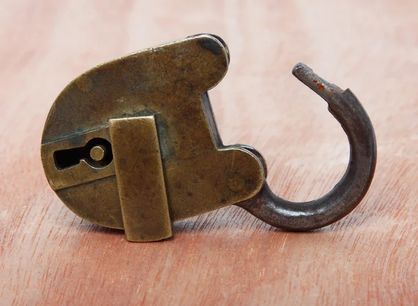 Old brass padlock on wood — Stock Photo, Image