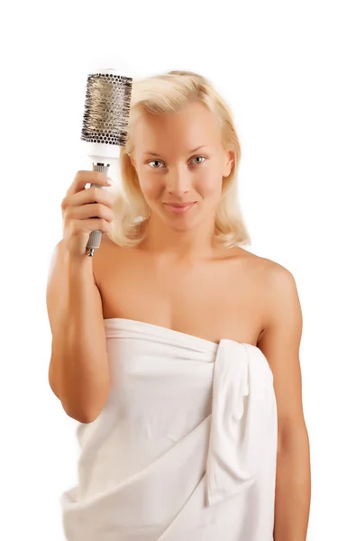 Cheerful blonde combs hair — Stock Photo, Image