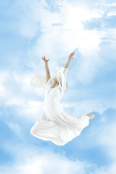 stock image Beautiful young woman jumping in sky