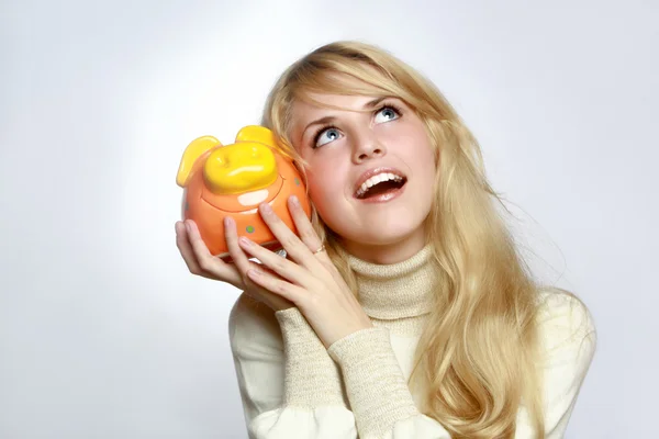 Beautiful woman with a piggy bank — Stock Photo, Image