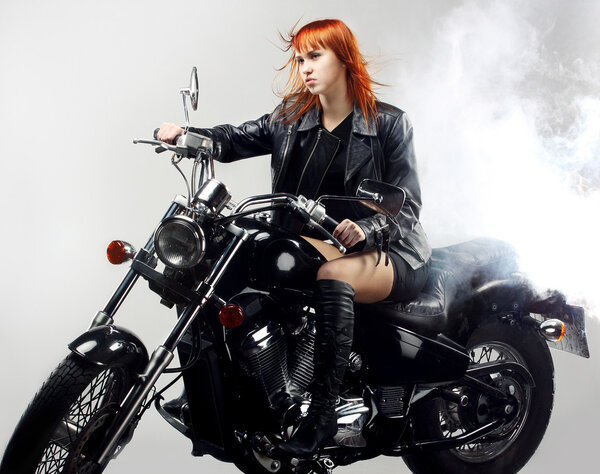 Red-haired girl on a motorbike