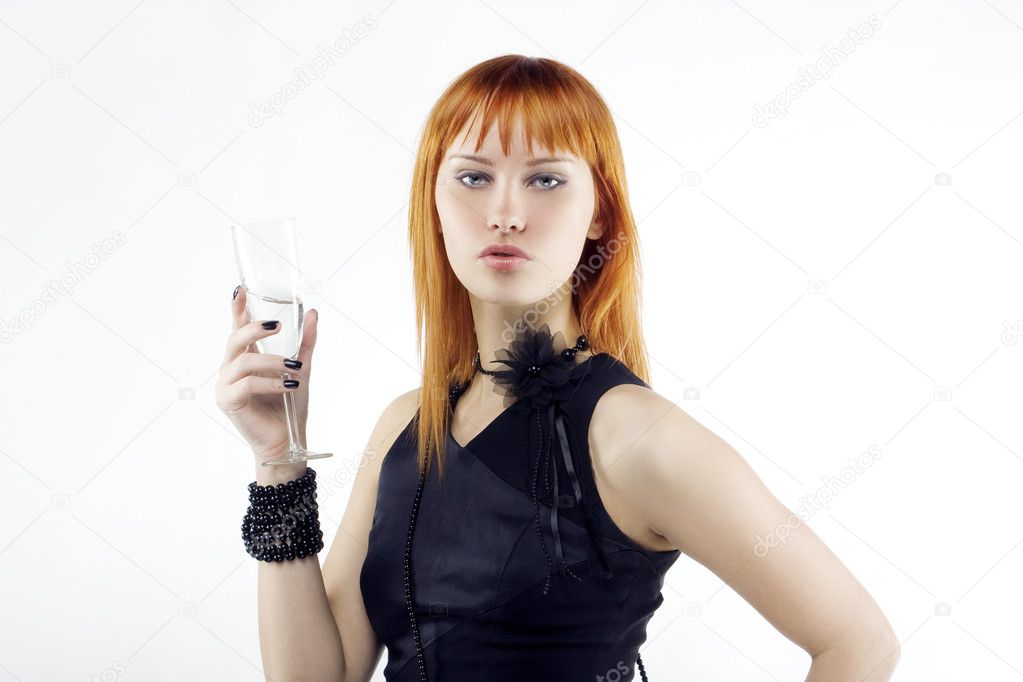 Beautiful red-haired girl lifts a toast