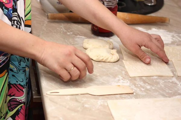 stock image The woman prepares pies with jam