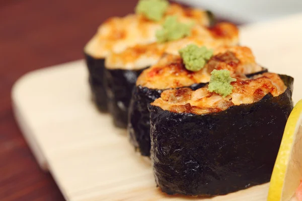 stock image Sushi and rolls on the wooden plate