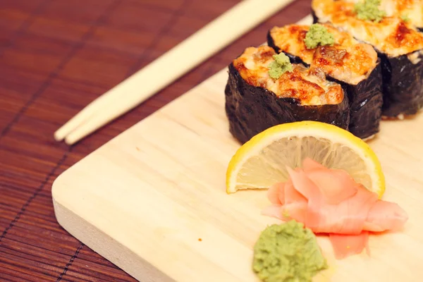 stock image Sushi and rolls on the wooden plate