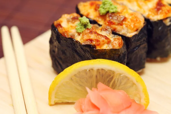 stock image Sushi and rolls on the wooden plate