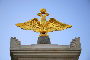 Gilt Double-headed eagle - Emblem of Russian Empire on a monument to Alexander I. Yevpatoria, Crimea, Ukraine. clipart
