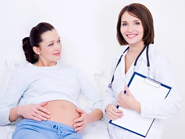 Doctor listen the stomach of a pregnant � Stock Photo � valuavitaly ... image