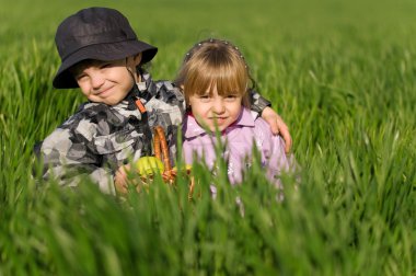 Little boy and girl in field clipart