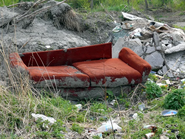 stock image Old red sofa in the dump