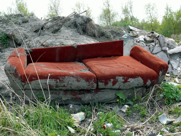 stock image Old red sofa in the dump