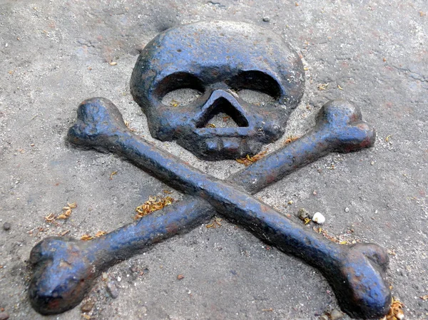 stock image Bronze symbol of death in gravestone