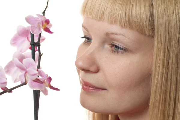 Portrait of a young woman with orchid — Stock Photo, Image