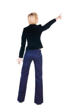 Young woman points at wall. clipart