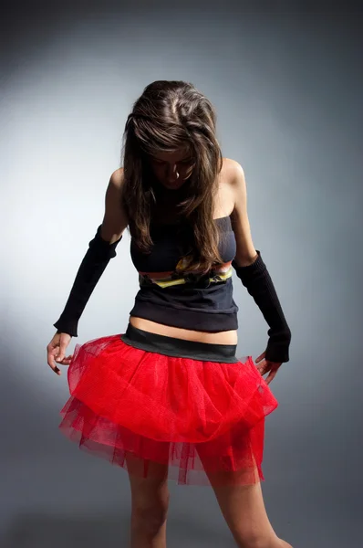Dancing girl in red skirt — Stockfoto