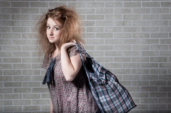 Tired redhaired woman with shopping bag. — Stock Photo, Image