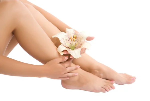 Женская нога и рука с цветами — стоковое фото