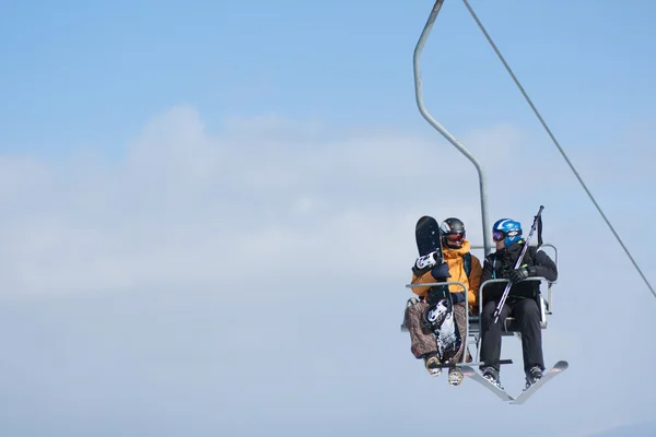 Skiers on a ski lift — Stock Photo, Image