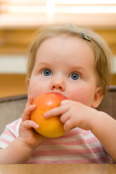 Cute little baby eating an apple — Stock Photo, Image
