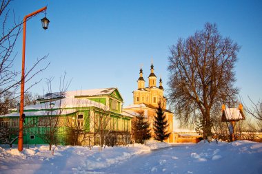 Rural house near to church clipart