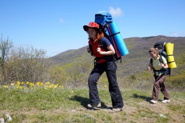 Girls with backpaks walking outdoor clipart