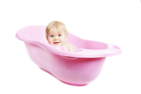 Baby girl bathing in the bath isolated on white Stock Photo