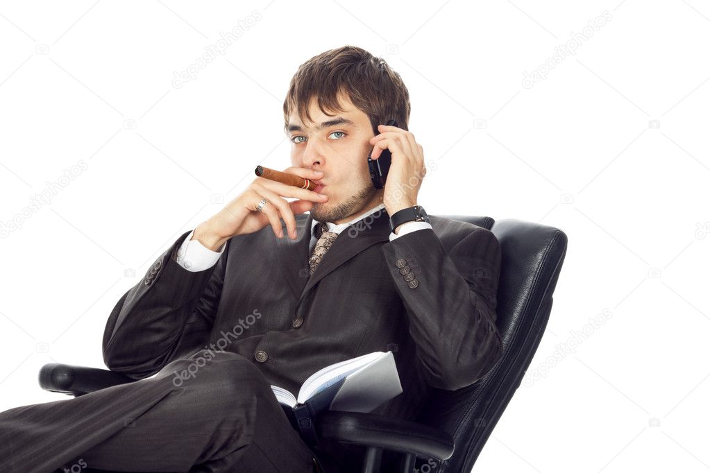 Young businessman smoking a cigar