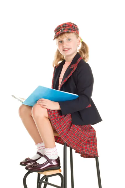 Девочка в школьной форме читает книгу — стоковое фото